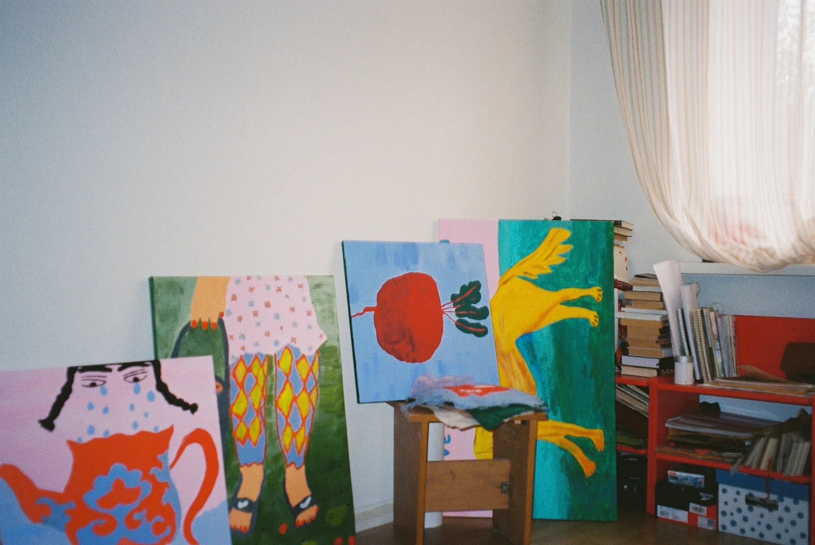 Colourful paintings arranged in the studio